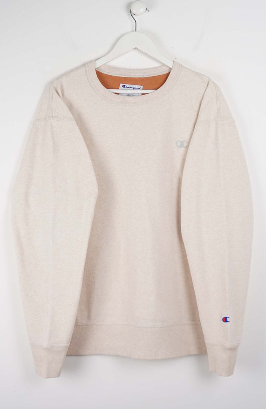 Beige sweatshirt with Champion logo on a white background