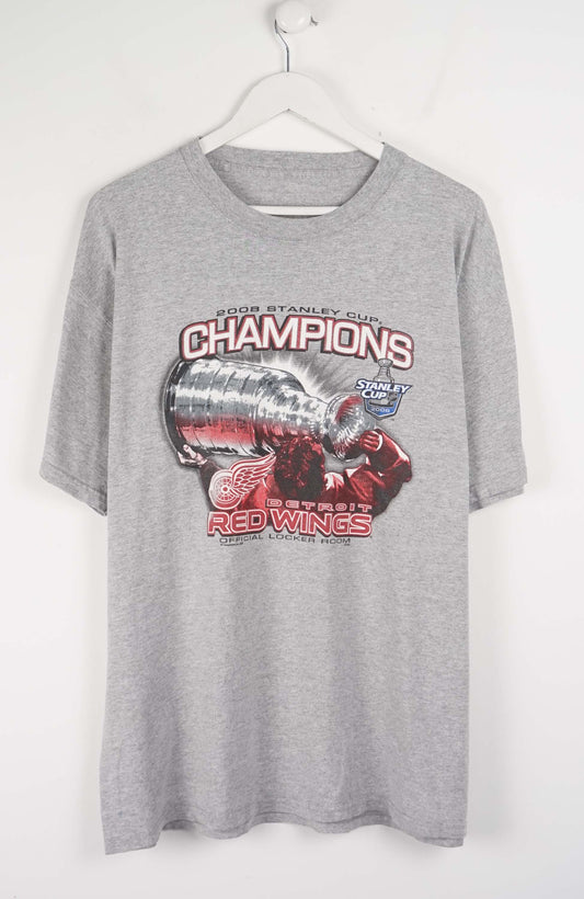 Gray t-shirt with Red Wings Stanley Cup Champions graphic on a white background