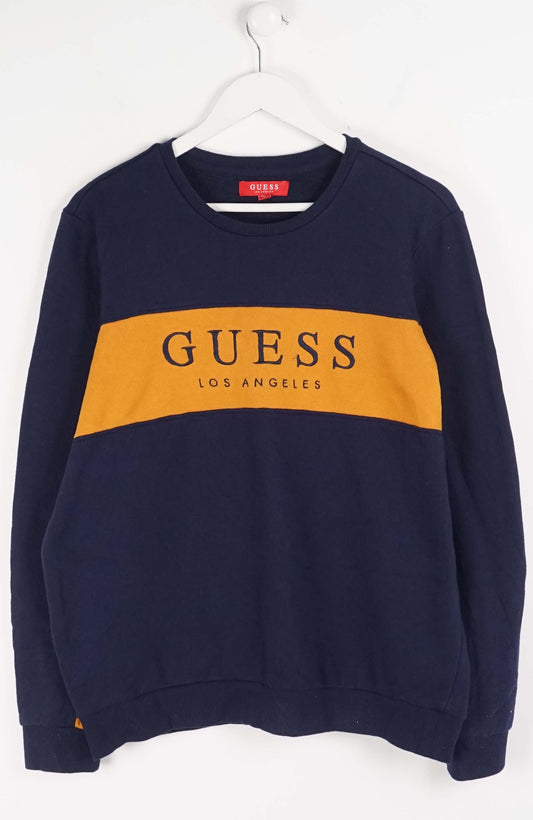 Navy blue sweatshirt with yellow Guess logo on a white background