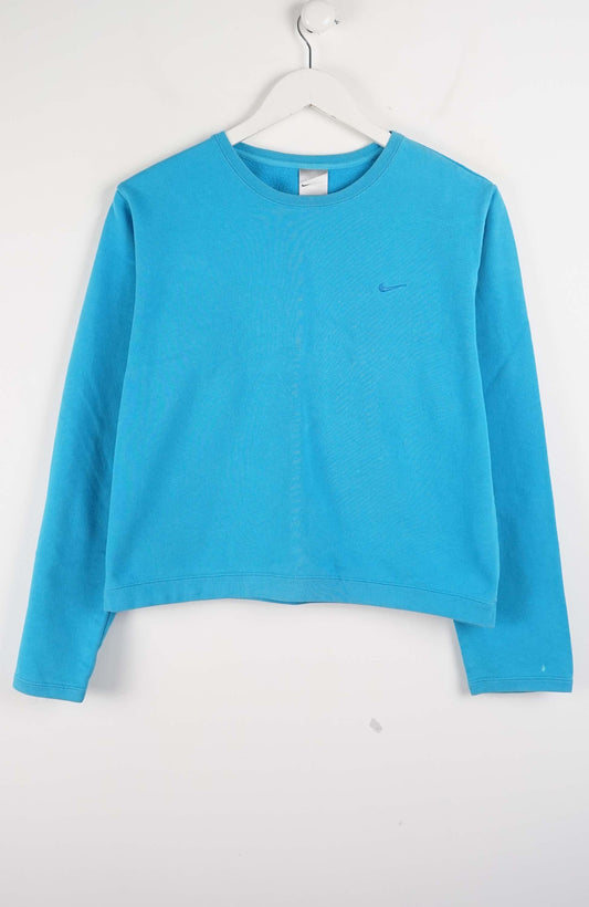 Blue long-sleeve shirt on a hanger against a white background