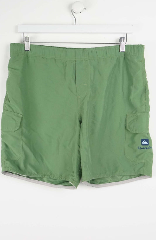 Green shorts with a brand logo on a white background