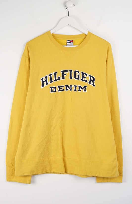 Yellow long-sleeve shirt with 'Tommy Hilfiger Denim' logo on a white background