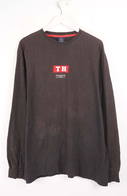 Brown long-sleeve shirt with a logo on a white background